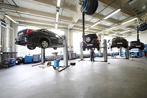 Auto garage that creates a lot of pollution with cars raised by machinery