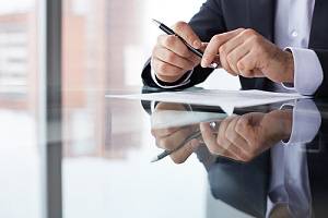 Business employee with paperwork at table