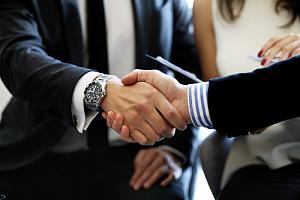 Future executive shaking hand of current executive