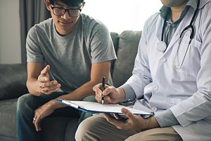 Man visiting doctor and discussing payment
