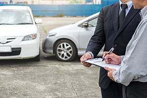 Person filling out car insurance forms