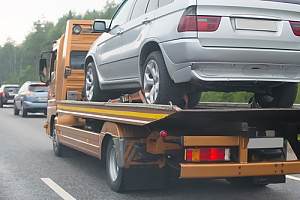 Tow truck with car on highway 