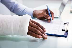 Injured employee filling out workers compensation paperwork