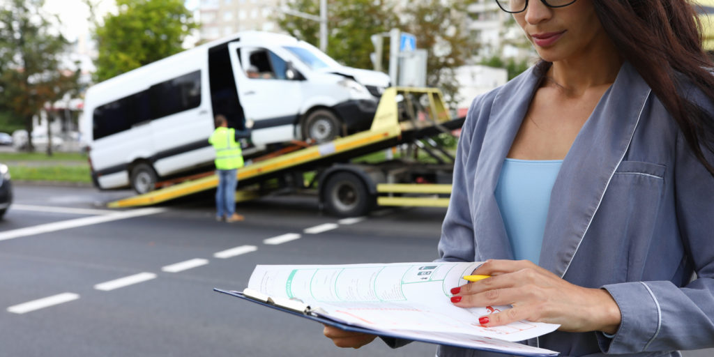 Woman with towing insurance filling out paperwork
