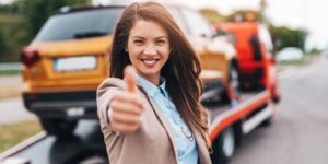 A happy customer on the side of road. Commercial towing insurance concept