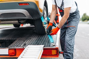 senior man working in towing service on the road