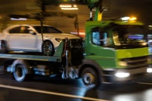 green truck towing white car