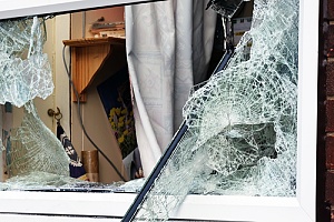 vandalized broken residential window
