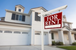 a home in the suburbs with a for rent sign