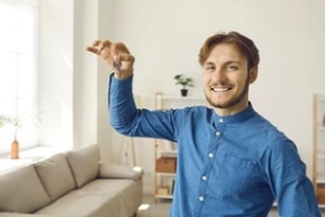 happy landlord holding home keys