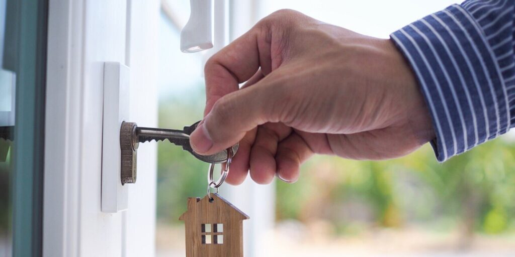 landlord unlocks the house key for new home