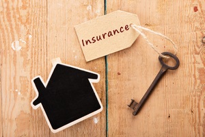 home insurance concept little house and old key