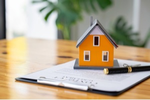 houses and contract documents on the desk