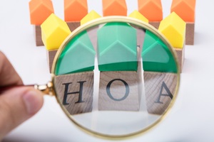 homeowner association wooden blocks seen through a magnifying glass