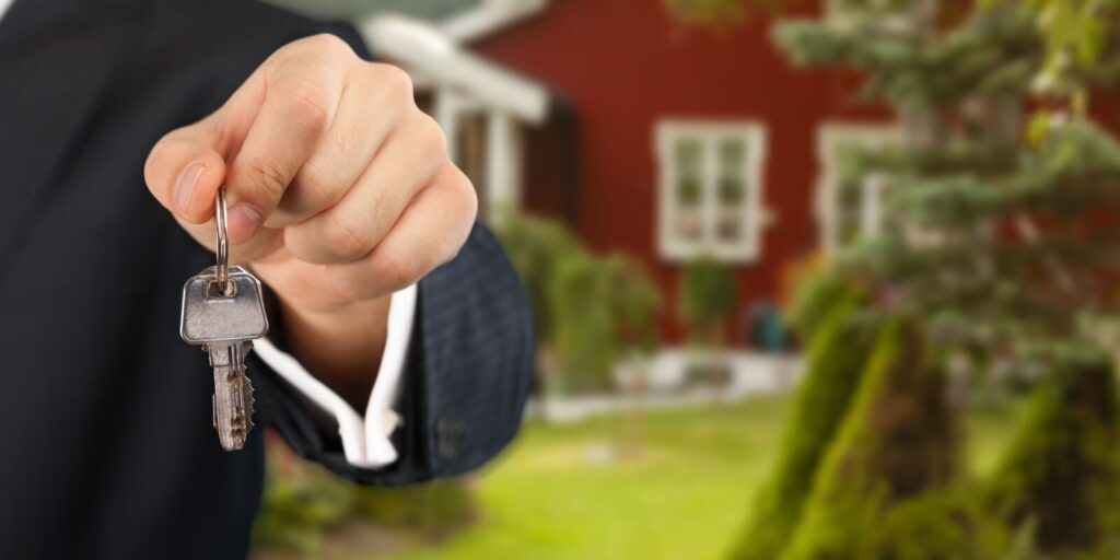 homeowner holding a new house key from a broker