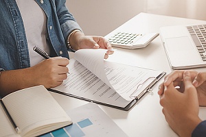 landlord signing an insurance policy for their property