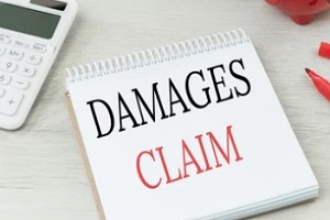 damages claims written on notepad