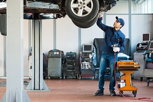 garage worker fixing car tyres