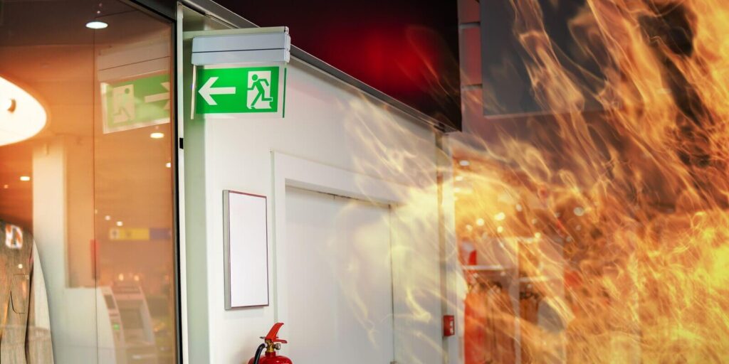emergency fire exit sign and fire in shopping mall