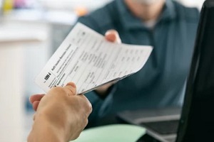 man giving health insurance form