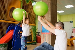 father with daughter enjoying in entertainment center