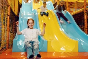 kids enjoying slide in fun activity center