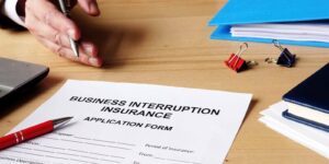 agent offers business interruption insurance application papers