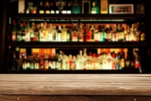 an empty bar with liquor bottles in blurred background