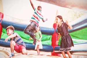 friends jumping on bouncy castle