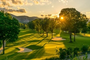 the sun sets over a new hampshire golf course