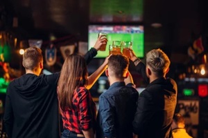 friends watches football on TV in a sport bar