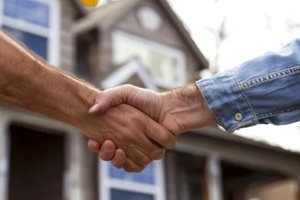 home renovation agreement handshake between homeowner and contractor
