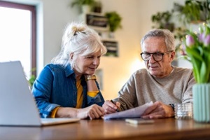 senior couple sitting at the table discussing home finances