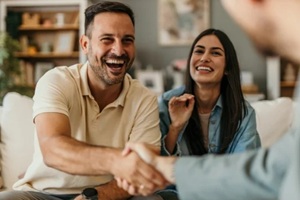 homeowners shaking hands with an insurance agent