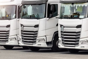 three commercial trucks parked