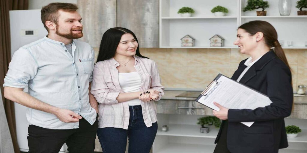Home Insurance Agent Talking to Her Clients about investment property insurance