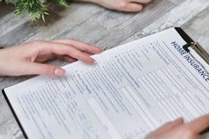 Person Holding form of Home Insurance