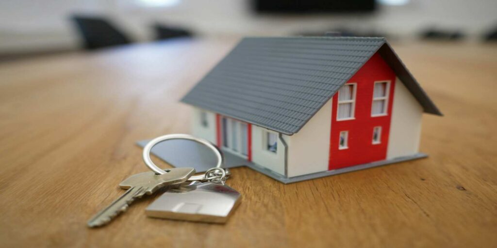 A Small House Model with Keys on Table