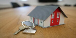 A Small House Model with Keys on Table