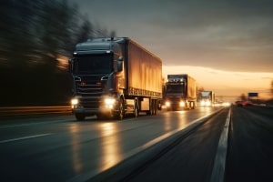 A Convoy of Trucks Going Through Highway at Night