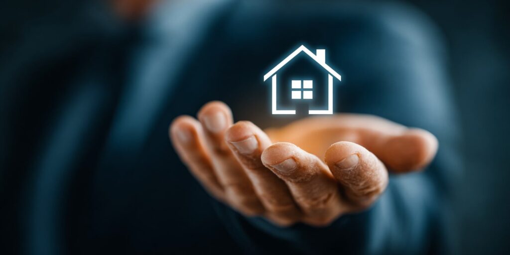 Man Holding Glowing Home Icon Showing Insurance Concept